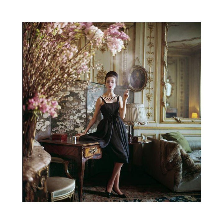 Original Limited Edition Mark Shaw fashion photograph. This is from a never published series taken by Shaw for LIFE magazine. Pictured here, a smoking model wears a Dior gown in the 17th century house where Manon Lescaut once lived, then owned by