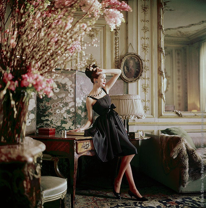 Original Limited Edition Mark Shaw fashion photograph. This is from a never published series taken by Shaw for LIFE magazine. Pictured here a smoking model wears a Dior gown in the 17th century apartments where Manon Lescaut once lived, then owned