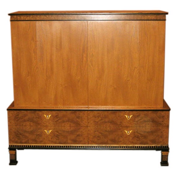 Swedish art deco/neo classical storage cabinet in elm and carpathian elm with inlaid ivory. Designed by Gustav Bergstrom ca. 1920. There are four carpathian elm covered drawers. The interior has a partition and four removable/adjustable shelves