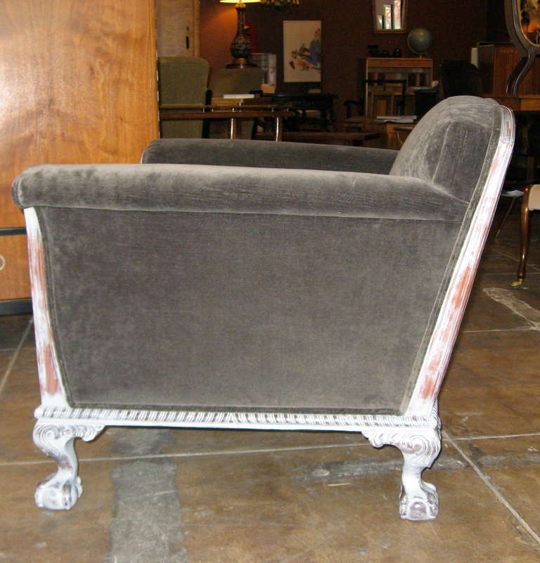 Highly unusual pair of Swedish Art Deco armchairs. Hand carving on entire exposed frame. Claw ball feet on both front and back legs. In classic Swedish pearl gray painted stain. Restored and recovered in charcoal gray velvet. Down filled loose
