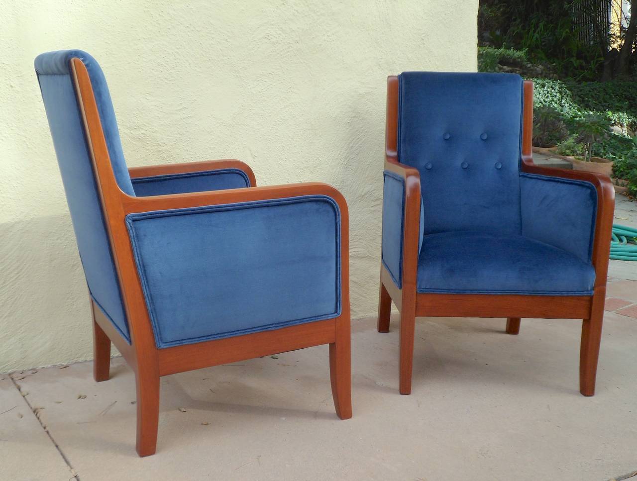 Pair of Swedish Art Deco era armchairs in mahogany. Beautiful restored and reupholstered in blue velvet by our woodworkers. These are a great compact profile for a small space. Made in Sweden, circa 1920.