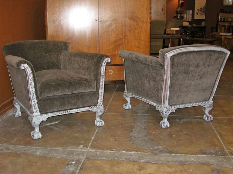 Highly unusual pair of Swedish art deco armchairs. Hand carving on entire exposed frame. Claw ball feet on both front and back legs. In classic Swedish pearl gray painted stain. Restored and recovered in charcoal gray velvet. Down filled loose