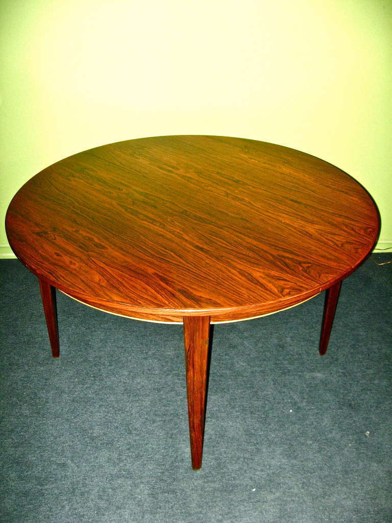 Danish Mid-Century Modern Extendable Rosewood game/dining Table. Table has two matching rosewood leaves. two Table round is 47.5