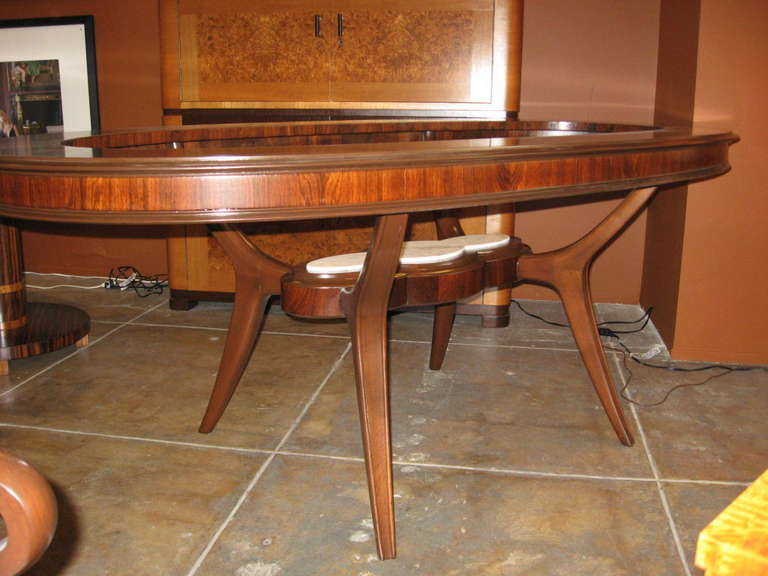 Mid-century modern oval dining table in rosewood and mahogany and marble. Glass top. Made at Bonta in Buenos Aires, Argentina in the 1960's.  This piece has been beautifully restored by our craftsman.
The price listed is the FINAL NET price, which