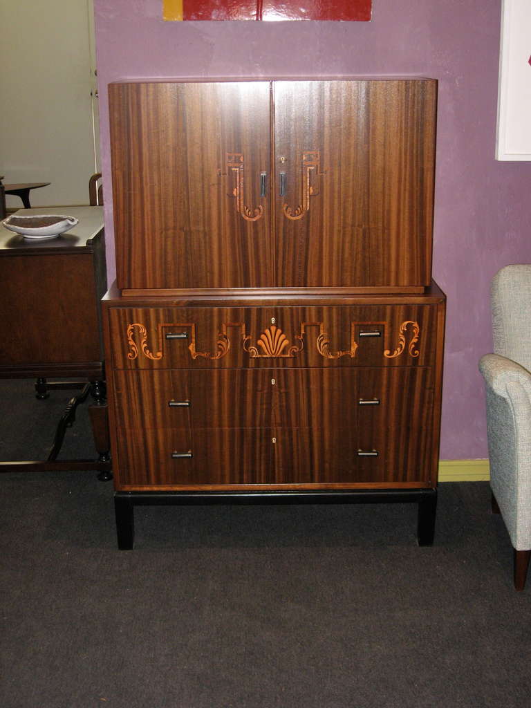 Swedish art deco era inlaid secretaire/chest of drawers in walnut, rosewood, ebony and birch woods. Interior in golden flame birch and walnut. Original metal and bakelite pulls. The perfect, compact work/storage solution. Made at Svenska