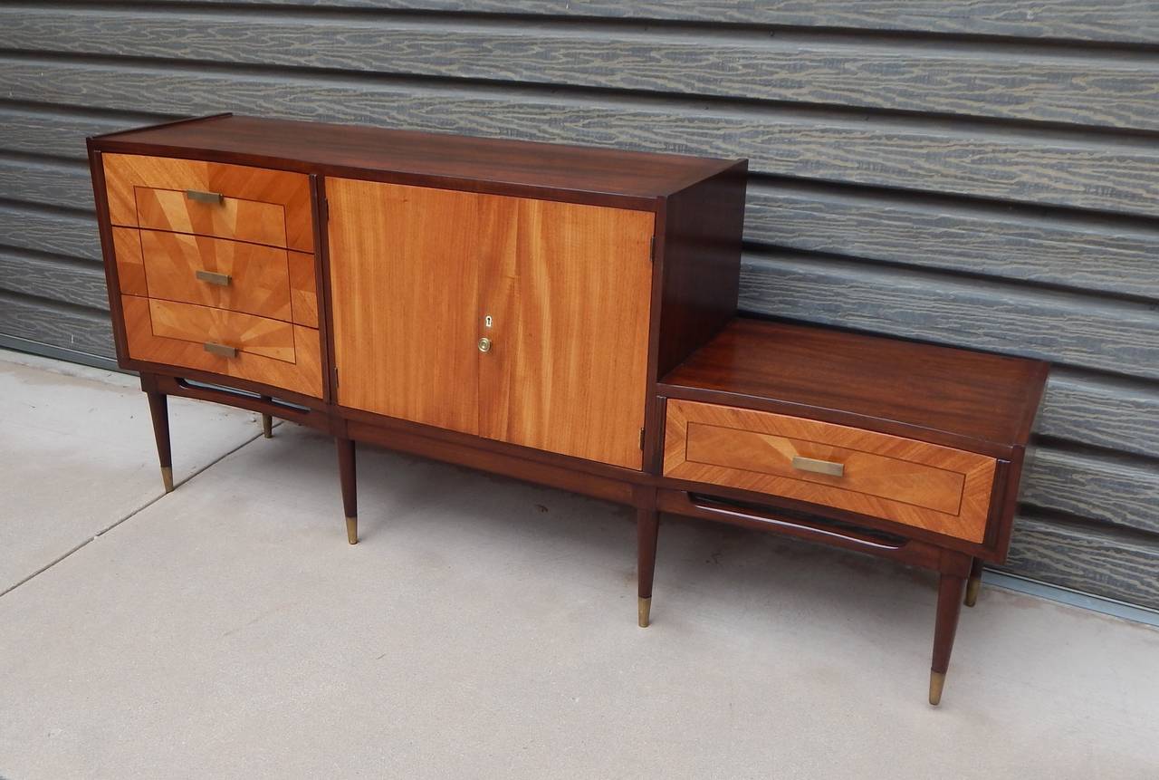 Argentine Mid-Century Modern storage cabinet or dresser rendered in satinwood, mahogany and petiribi. Solid nickel pulls. Restored and in excellent condition. This item has been discounted to final sale price. Please take note of this before