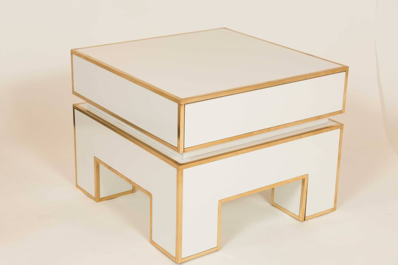 Glossy white laminate side tables or nightstands from a series by Alain Delon for Maison Jansen. Tables were manufactured by Mario Sabot in Italy, in 1972. Brass inlay accentuates the edges. Each table has a concealed single drawer on top, 4.25