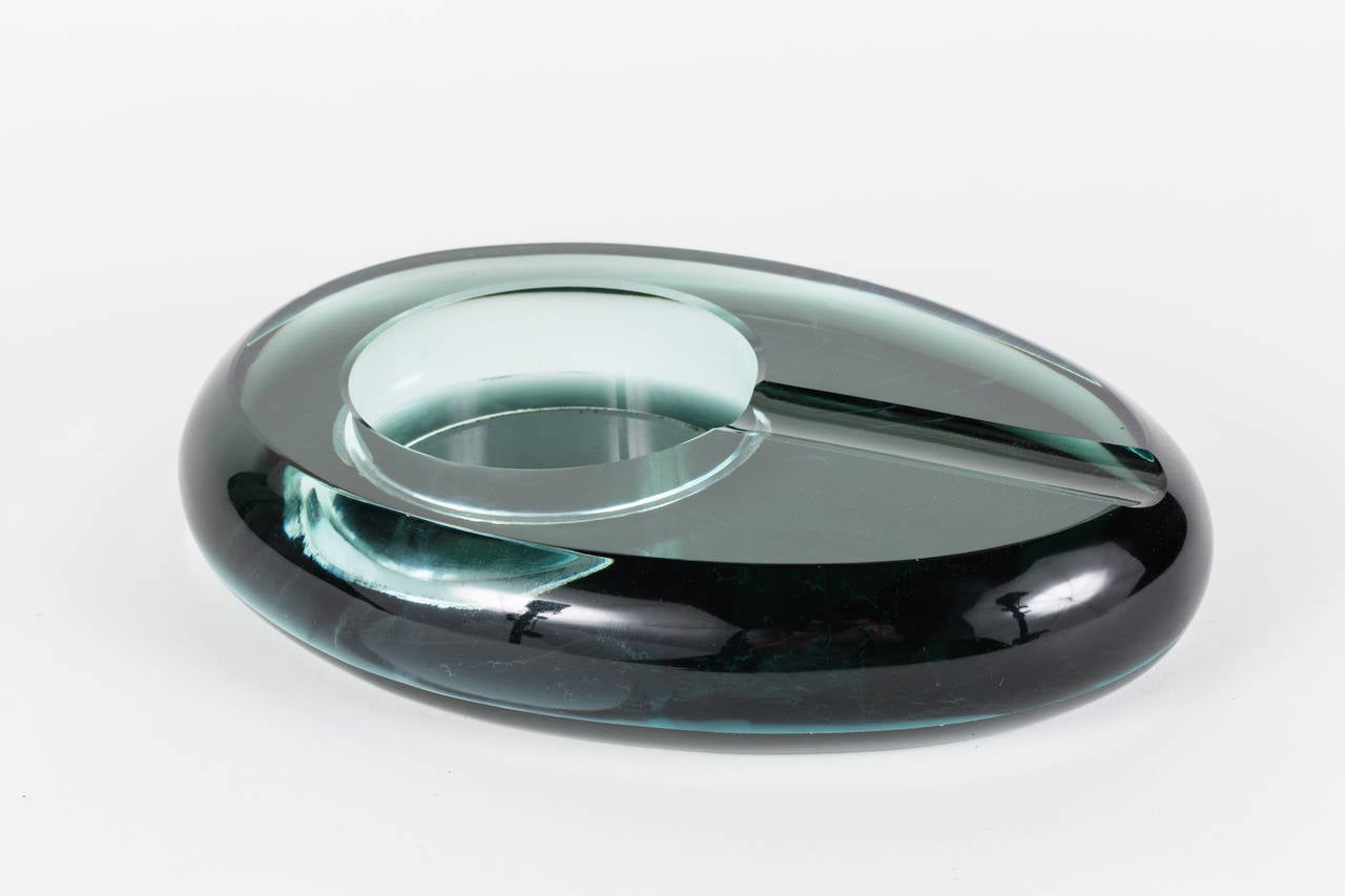 Impressive and heavy oval cigar ashtray with cigar rest sleekly cut out. Glass is an exceptional color has some scratches to underside but is in otherwise very good condition.
