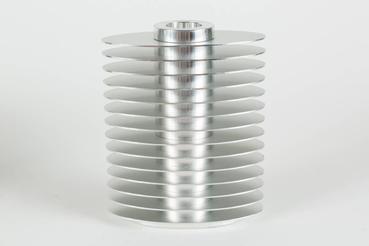 Set of three candleholders, in a Streamline Moderne design, made from brushed and polished stainless steel by artist and designer, Avedis Baghsarian.

"After 30 years as a respected and eminent photographer, Avedis found photography no longer