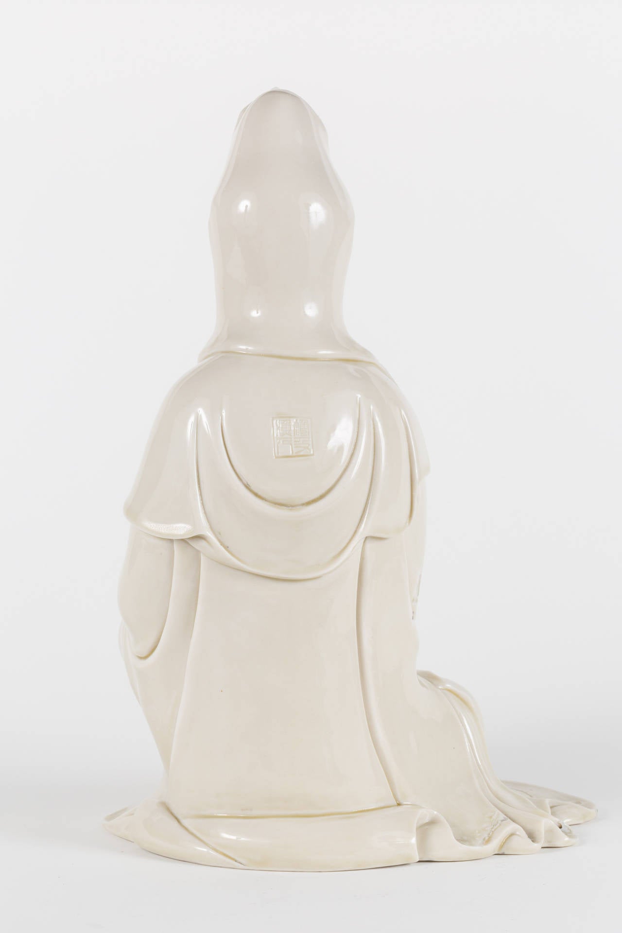 Lovely example of a latter 19th century porcelain statue of Kwan Yin, an East Asian deity of mercy. She is detailed with exceptional (porcelain) beading and gracefully posed. The folds of her robe are elegantly rendered and she features a maker's