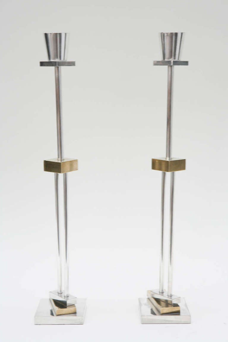 A thoroughly modern pair of candlesticks, designed by Ettore Sottsass for Swid Powell, in the signature asymmetrical Memphis style. Stamped on the underside of the bobeche with both names and 