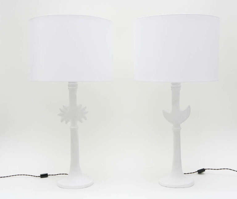 A chic pair of cast resin/plaster sun & moon table lamps after Diego Giacometti by Sirmos. New custom white silk shades.