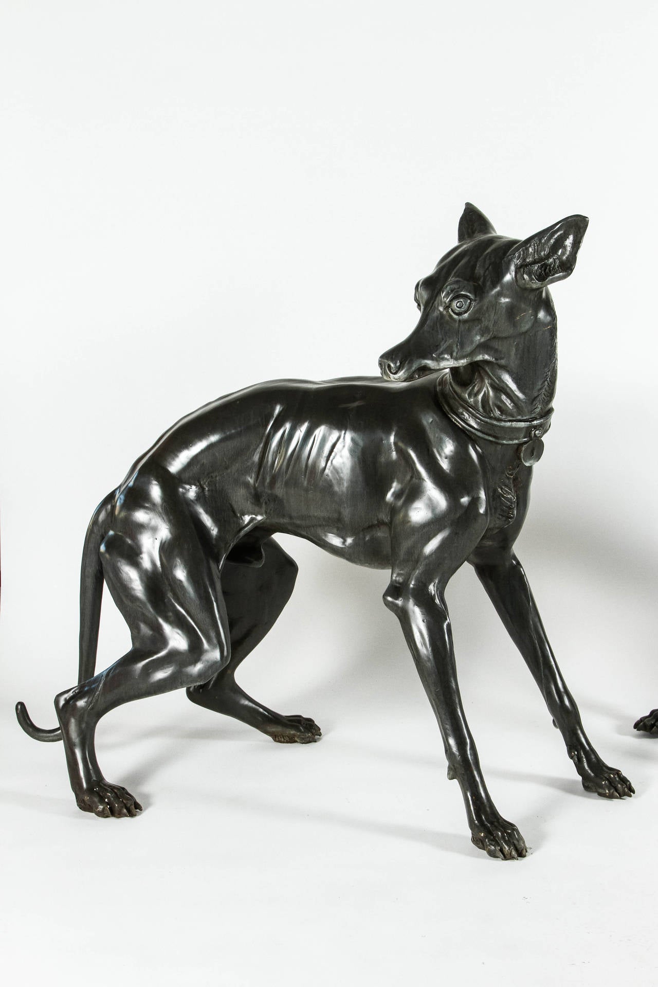 This fierce pair of bronze dogs would be impressive flanking an entry or drive. They have been thoroughly cleaned and hand waxed but do show some signs of their life outdoors. Heavy and substantial sculptures with very realistic details. The bronze