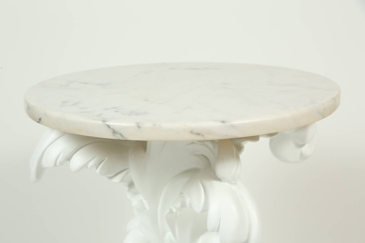 A fun, matte white Rococo-style cast plaster side table with plumes and curlicues topped with a 7/8