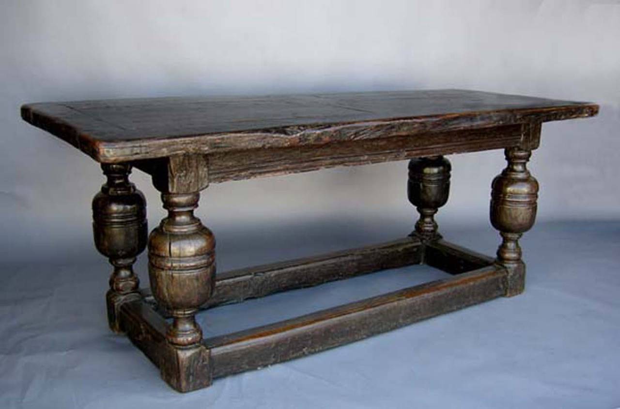 Solid oak Baroque table with bulbous turnings. Framed table top. Worn surfaces. Old world design.