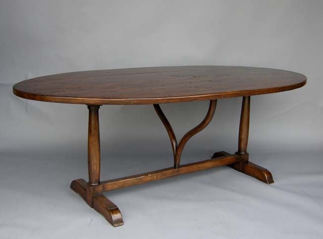 Custom oval walnut wine tasting dining table with wishbone shaped support and column trestle base. Shown here in walnut with a medium distress. Can be made to order in any size and top configuration, in walnut, oak or mahogany, in variety of