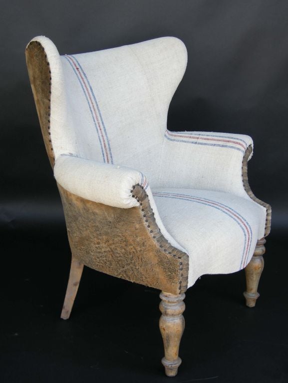 Custom made wingback chairs with soft lambskin backs and vintage feedsack/linen upholstery. Can be made in COM  or all leather or all linen.
made in Los Angeles buy Dos Gallos Studio.