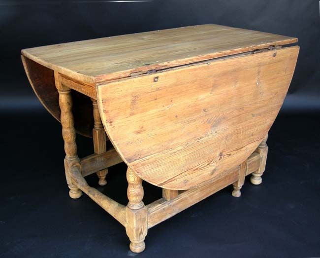 Early 18th century American pine gate leg table with drawer from  New England. When both sides are down it measures 46.5x25x30H
FOR OUR COMPLETE INVENTORY PLEASE GO TO www.dosgallos.com