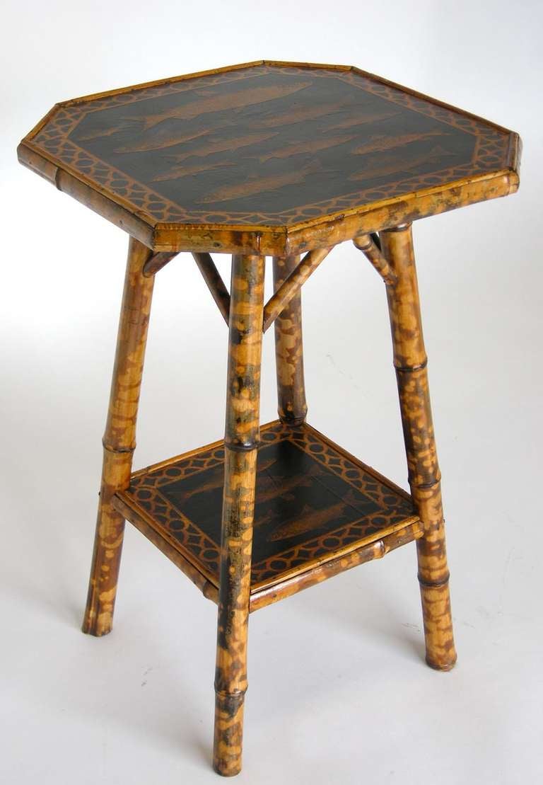 19th c. English bamboo side table with shelf and contemporary fish decoupage on black background.