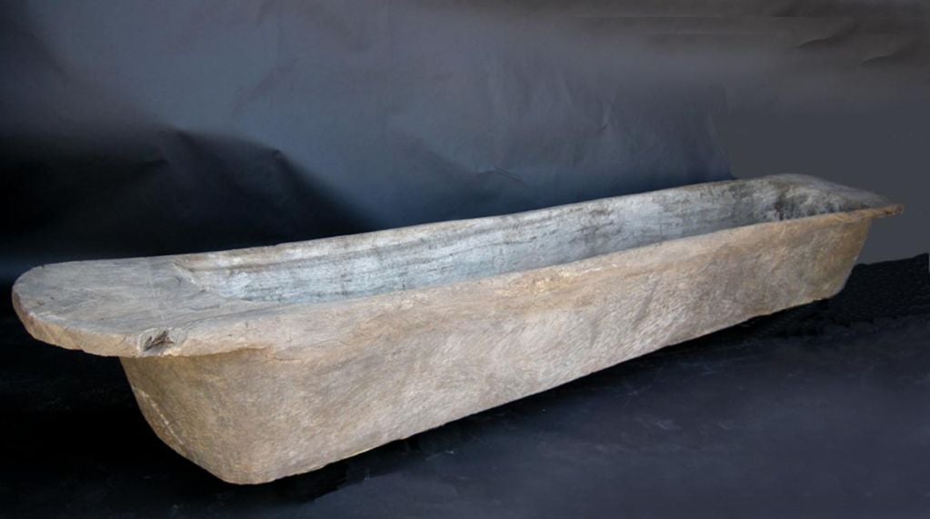 Very long massive wooden trough or canoa. Can be turned upside down to be used as bench