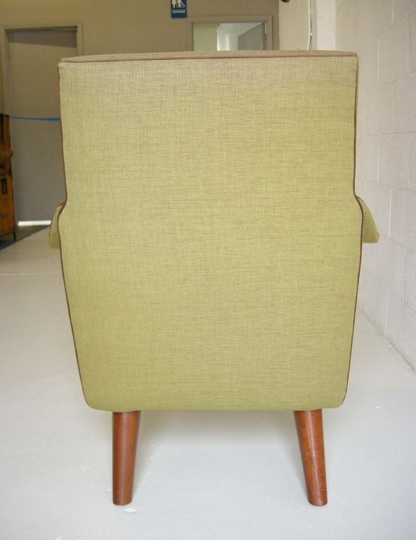 ONLY ONE AVAILABLE: Streamline modernist chair with thin curvy arms, hand stitched in a green linen piped in brown ultra suede. Measures: Width of armrest is 5