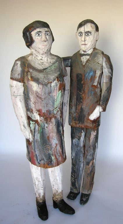 Primitive and whimsical folk art sculptures of the painter Anton Raderscheidt and his wife made by artist Jim Lawrence, 1983. Two parts.   
Woman measures 17x14x59H and man measures 21x12x62H
FOR OUR COMPLETE INVENTORY PLEASE GO TO