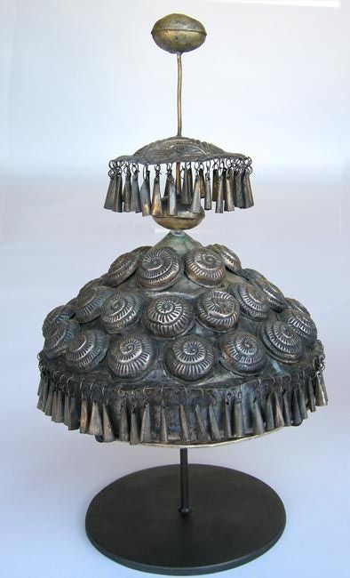 19th c. Chinese wedding headdress in nickel and tin with circular applied decorations and dangling tassels. Custom iron stand.
