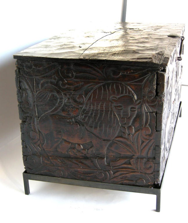 19th c. carved grain chest on contemporary iron base. Front drops down and there is a shelf inside. Dovetailed throughout and each of the six sides are constructed of one wide board. Carvings are of stylized lions and wheat.
FOR OUR COMPLETE