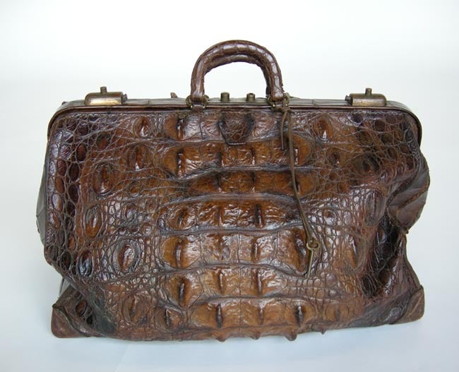 Beautiful crocodile doctor's bag from the early 1900's, with key and lock intact. Leather needs tlc and some smaller repairs.