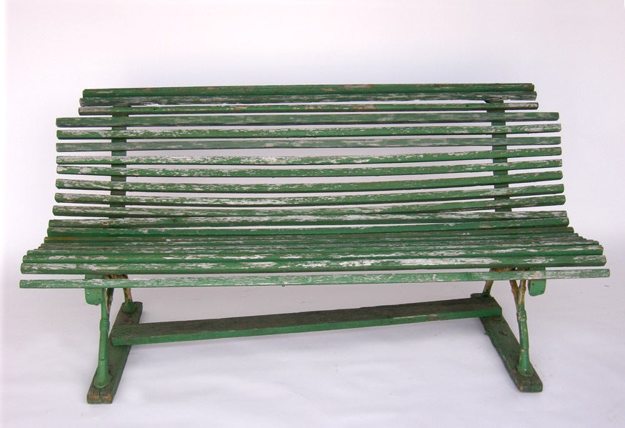 Typical 19th century early 20th century Swedish garden park bench. Green slatted garden bench with iron base. Great old patina.