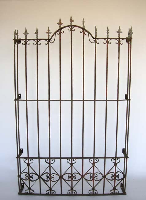 19th c. iron window grill with traces of paint. Beautiful old patina. Graceful lines. Can be sold separately or as a pair.
