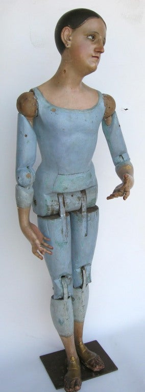 Beautiful, articulated virgin saint with intricately carved facial and hand features. Face and hands are beautifully and realistically painted. Iron stand