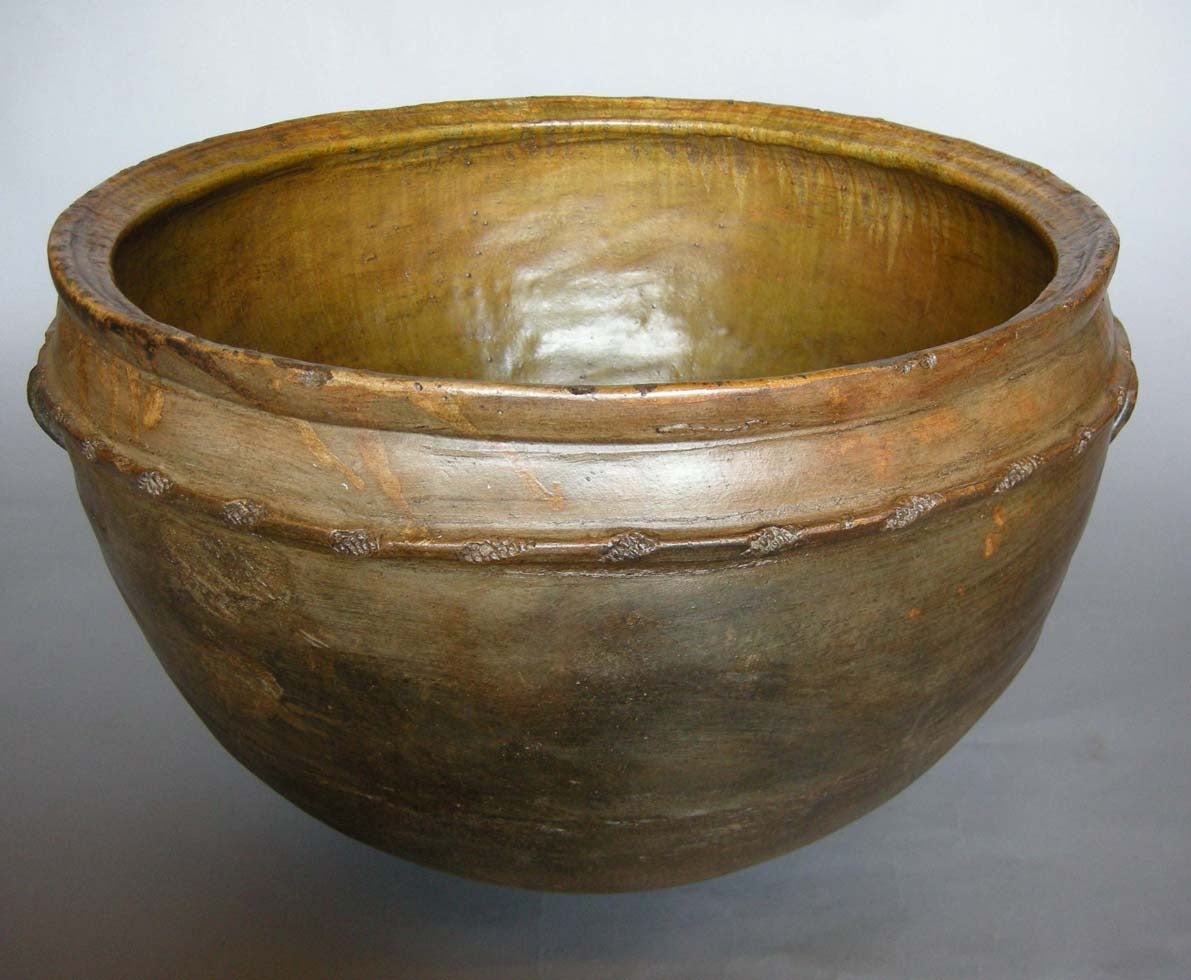 19th c. Guatemalan  ceramic olla - pot. Earth tone glaze, four handles and applied molding. In very good shape for its age. Originally used for water and cooking.  Can be used for planting. Lovely green patina.  