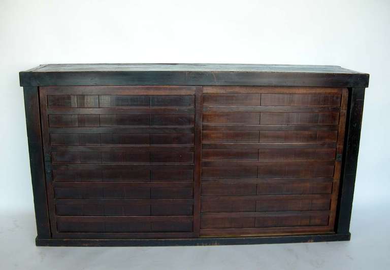 Chest with two sliding doors with three original interior shelves. Wonderful dark patina. in original good, antique condition with great style and function.