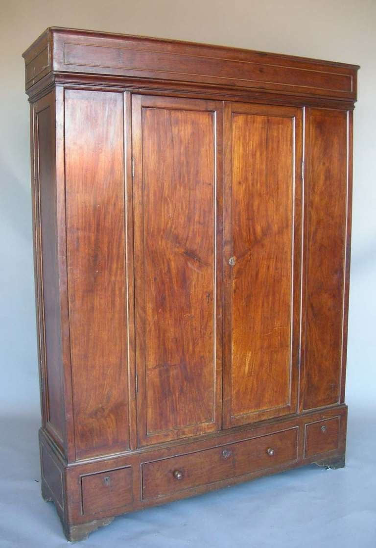 19th c. cedro wood wardrobe with six interior shelves. Each side has secret locking panels with an additional six interior shelves.
Three drawers on the bottom. Original locks and keys. Interior depth is 14.75