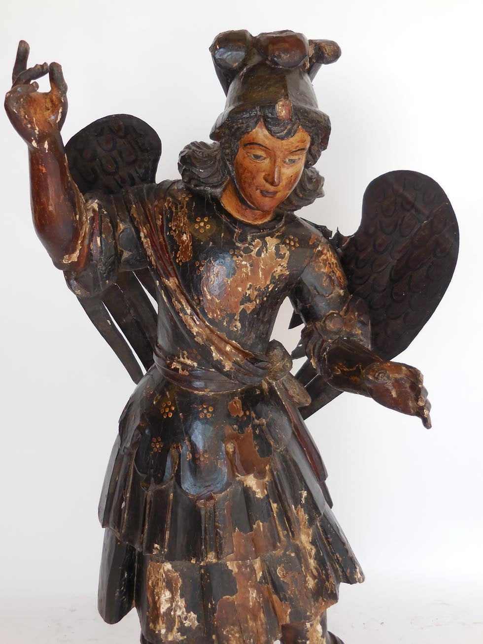 Large 18th century polychromed Saint Michael with tin wings. Beautiful facial features and hand-carved and hand-painted details throughout. San Miguel measures 43 inches high and he is atop a base that measures 17.5 x 8.