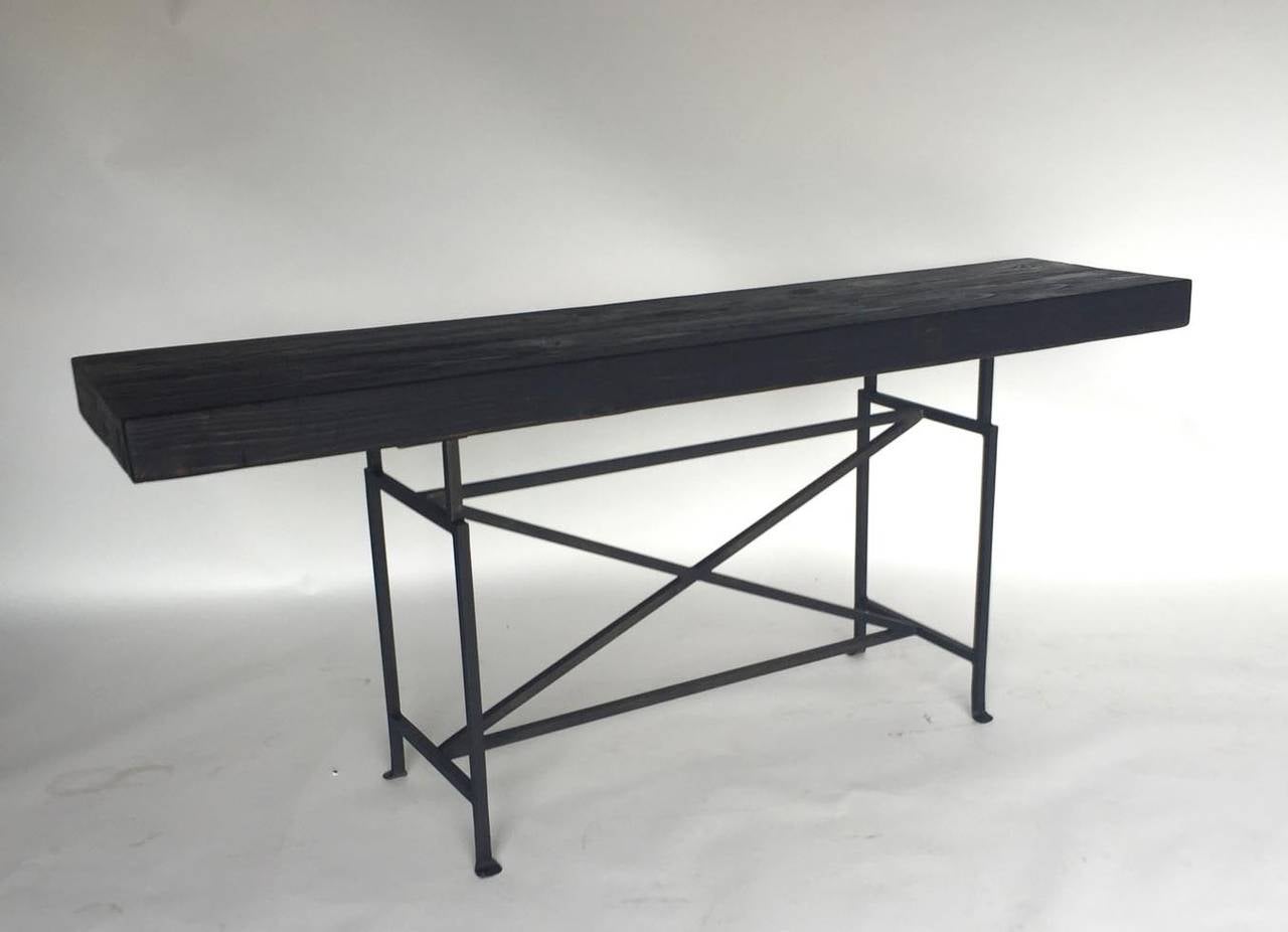 100 year old reclaimed Douglas fir with dark matte finish on hand-forged iron base. Top measures 3.25