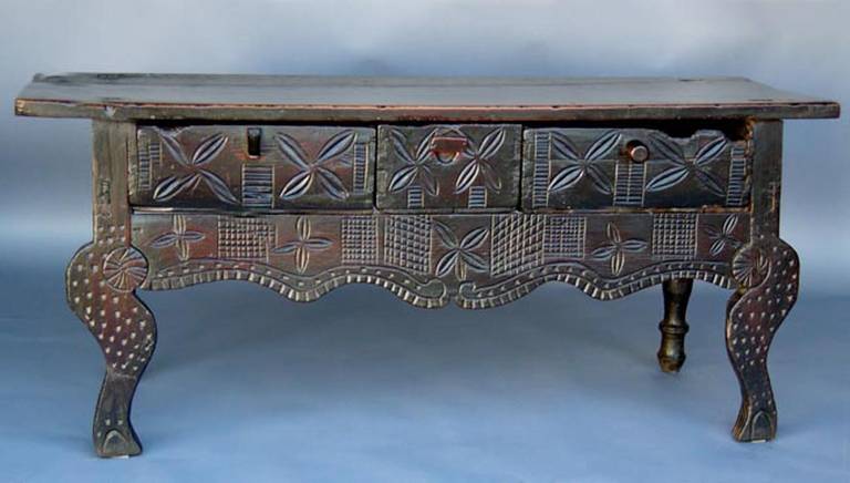 Gorgeous 19th century Nahuala (animal spirit) table with intricate carvings from the highlands of Guatemala. Three drawers with three different kinds of handles, very Rustic and folk artsy!
Front legs are carved and a primitive interpretation of a