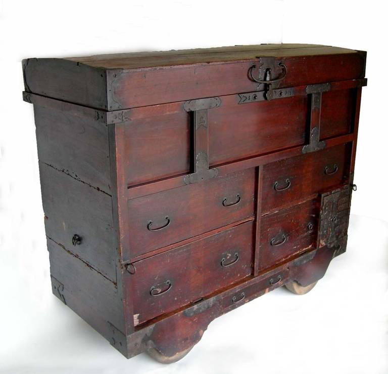 This chest on wheels is a very nice one. All original drawers and hardware. 
 During the Edo period, houses, being wood, often caught fire. Residents would put their belongings from the home and wheel it to the streets.  The roads would become