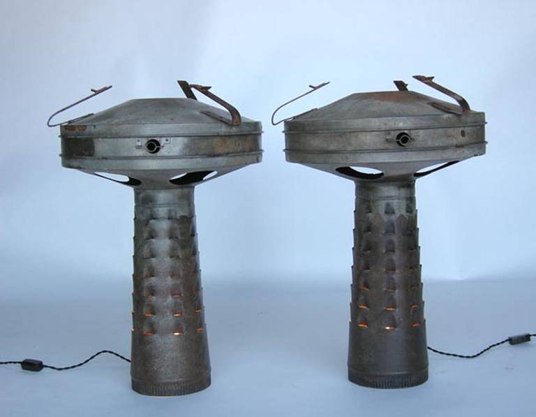 Pair of vintage aluminum smudge pot lamps. Smudge pots were used for keeping the citrus trees and fruit warm during the winter.
23Dx31H