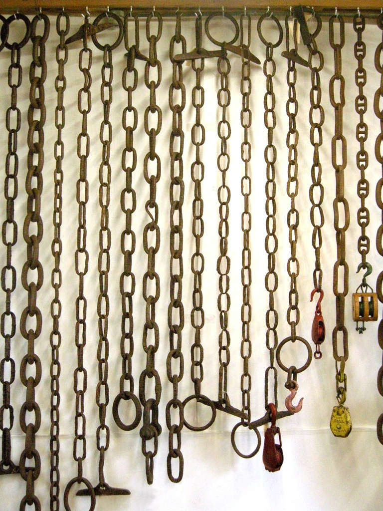 Collection of antique chains and pulleys in various sizes and lengths. Used as a room divider. Great patina throughout. They range from $550 - $1,500 each