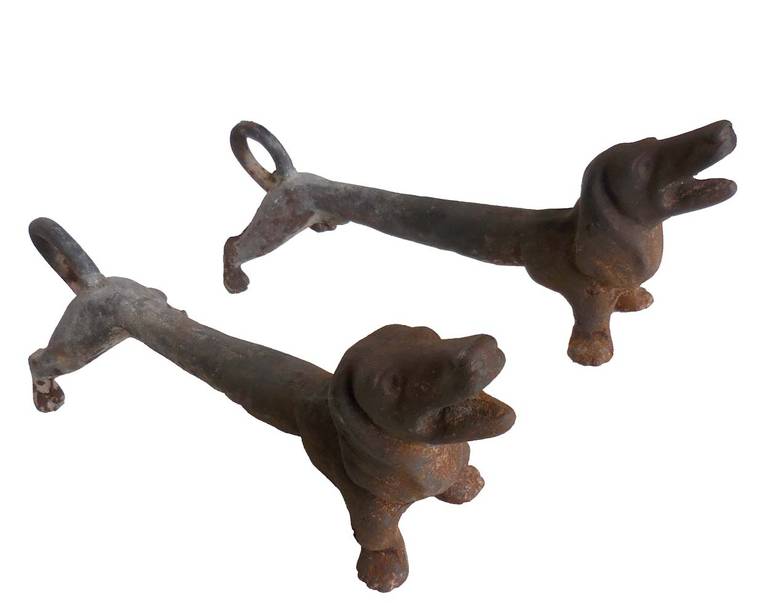 Short legs and long body make these vintage iron Dachshunds the perfect fit in your fireplace!