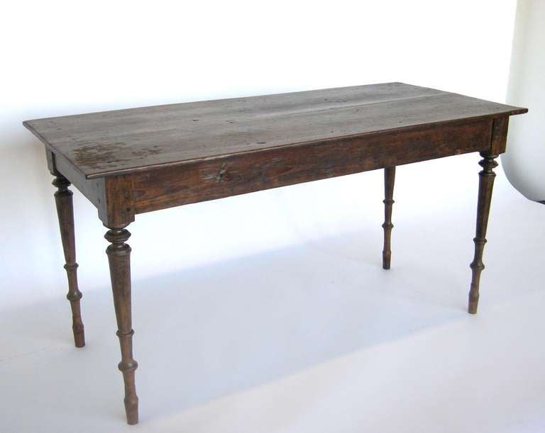 19th century teak wood table/desk from Java. All original except for extensions on bottom of the legs. Rustic and elegant.