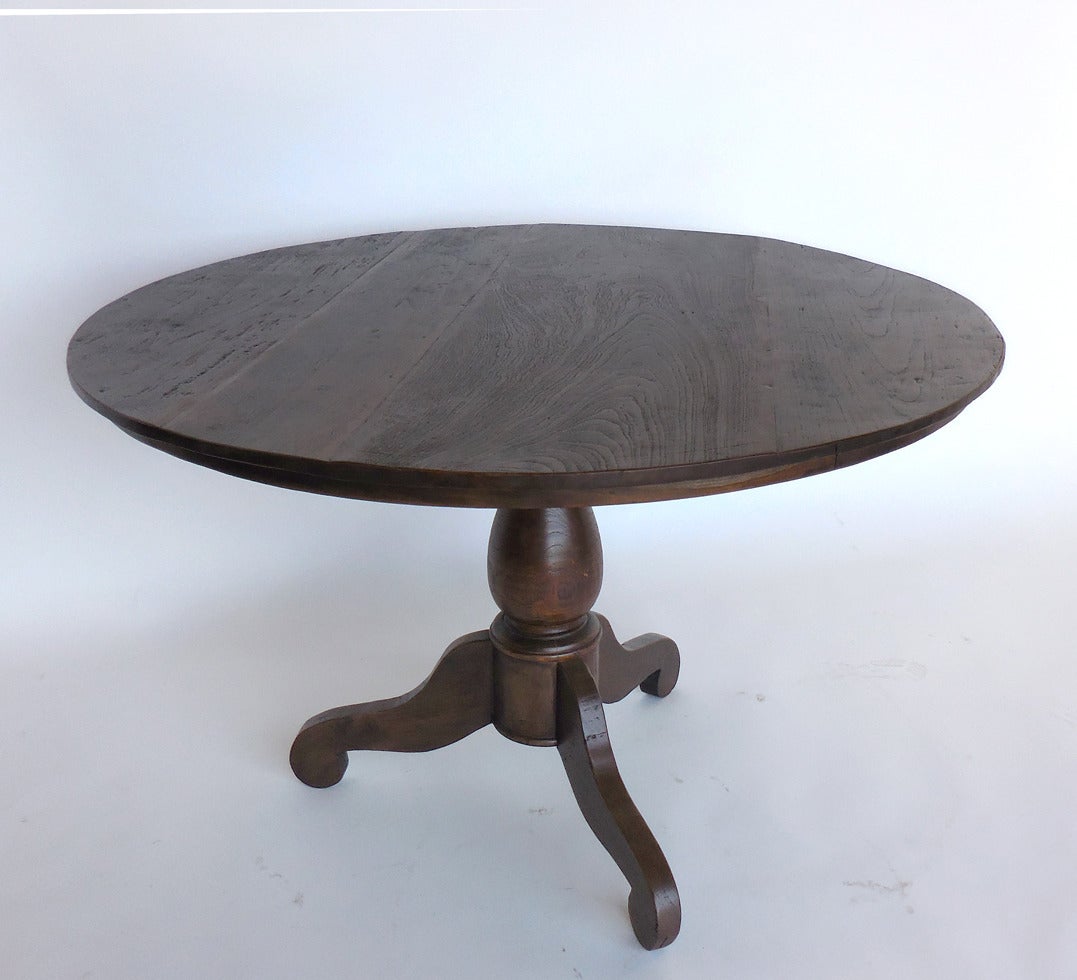 Round teak table with pedestal base. Beautiful wood and patina.