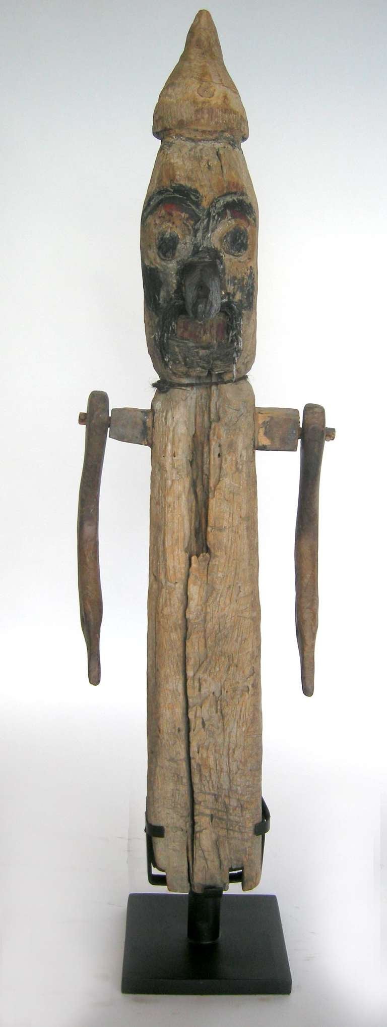 Large antique wooden scare crow used in a rice field from Bali. Arms swing. A great character and piece of folk art! On custom iron base