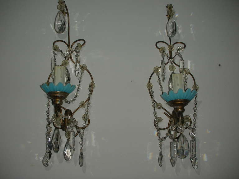 Pair of antique french sconces, circa 1900. Single light, metal frame dressed with cut crystal and beaded chains.  Opaline bobeches.  European wiring intact, and they are ready for your custom wiring.