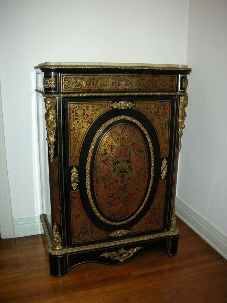 Beautiful boulle work cabinet with one large door and one drawer.  Faux tortoise and cut brass work. Beautiful example of refined boulle work. Black lacquer finish. Dovetail construction.
3 flaws are worth mentioning only for accuracy. There is a