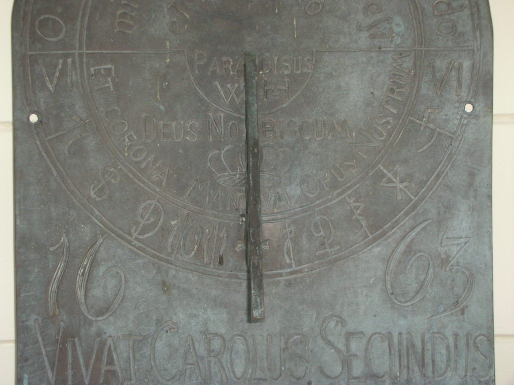 Antique bronze wall sundial with etched date, 1663, and inscriptions. Mounted on a wall, this type of sundial will be set for your latitude and the exact aspect of your wall. Very interesting piece. Etched with Vivat Carolus Secundus across the