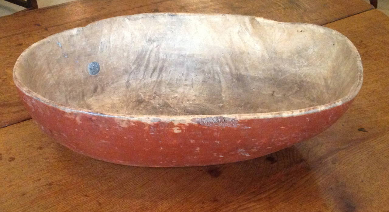 Wonderful early 19th century Swedish painted burl bowl having organic shape and original Swedish red paint, the interior well patinated and having several original metal hole plugs.