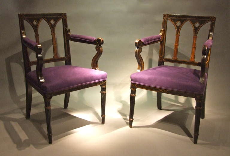 Fine pair of Regency period painted gothic armchairs, the square backs with quatrefoil piercing and arcaded arches with trompe-l'oeil cluster column supports, the padded arms with scroll ends and supports, over upholstered seats, the front legs